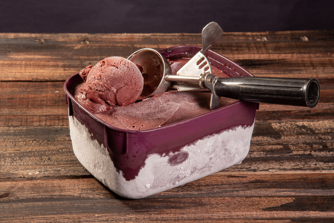 Close-up of frozen Brazilian açaí in a purple box. Fruit of Amazon (Acai). Top view