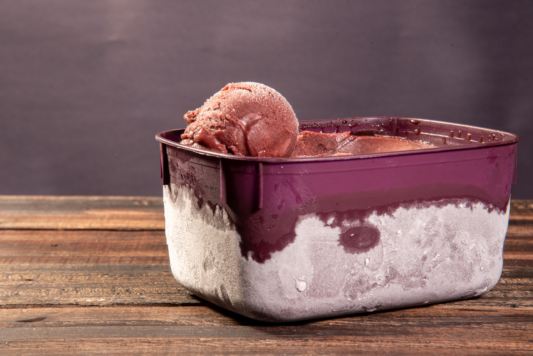 Close-up of frozen Brazilian açaí in a purple box. Fruit of Amazon (Acai). Top view
